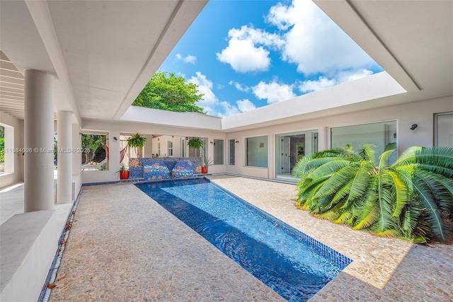 view of swimming pool with a patio area