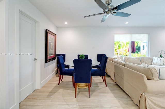 dining area with ceiling fan and light hardwood / wood-style flooring