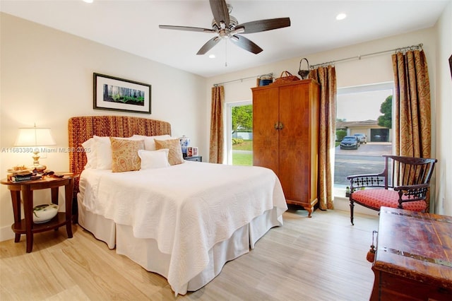 bedroom featuring ceiling fan, access to exterior, and light hardwood / wood-style floors