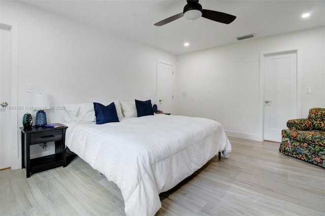 bedroom with light hardwood / wood-style flooring and ceiling fan