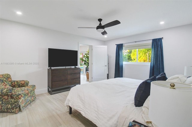 bedroom with ceiling fan and light hardwood / wood-style flooring