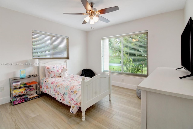 bedroom with ceiling fan and light hardwood / wood-style floors