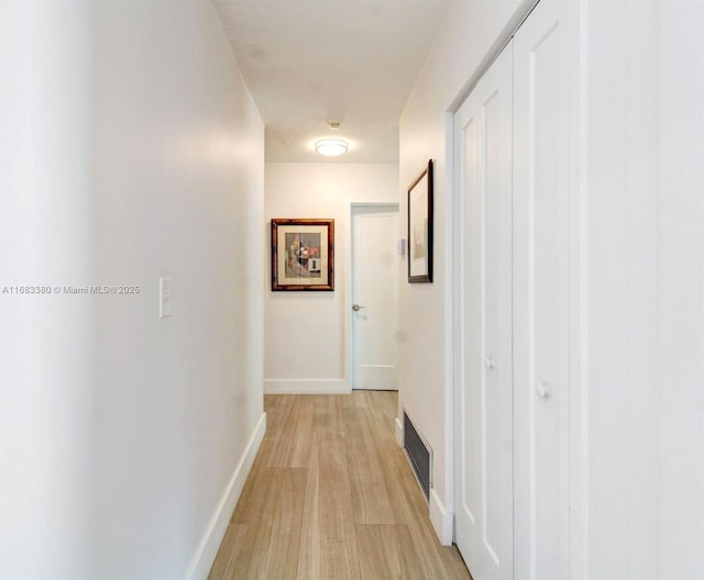 corridor with light hardwood / wood-style flooring