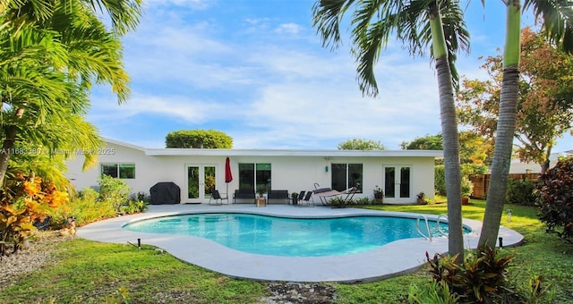 view of pool featuring a patio area and french doors