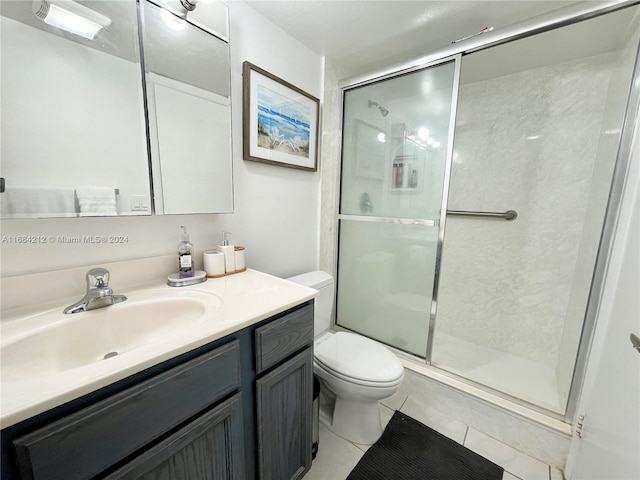 bathroom with vanity, tile patterned floors, toilet, and walk in shower