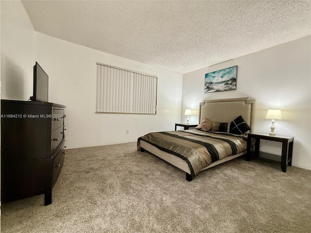 bedroom with a textured ceiling and carpet