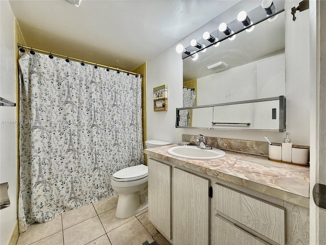 bathroom with vanity, a shower with curtain, toilet, and tile patterned floors