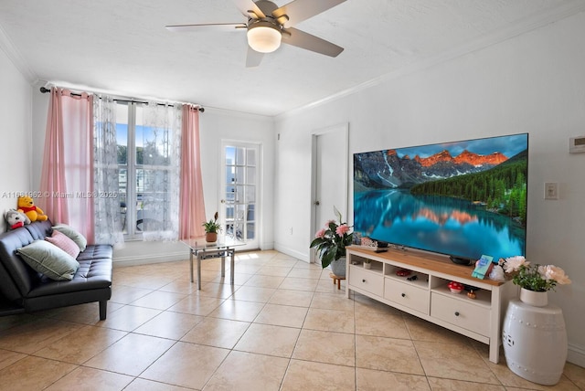 living room with light tile patterned floors, baseboards, ornamental molding, and a ceiling fan