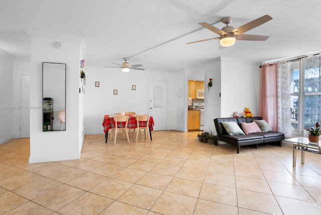 living room with crown molding, light tile patterned floors, and a ceiling fan