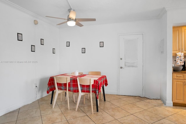 dining area with light tile patterned flooring, baseboards, ornamental molding, and ceiling fan