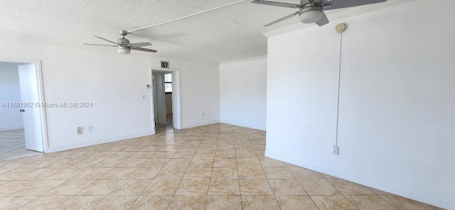 spare room featuring ceiling fan, crown molding, and a textured ceiling