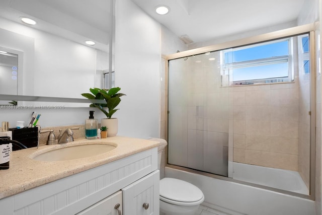bathroom featuring toilet, recessed lighting, vanity, and shower / bath combination with glass door