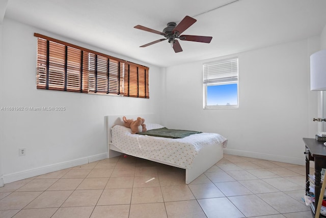 bedroom featuring light tile patterned floors, baseboards, and ceiling fan