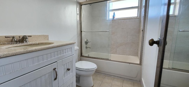 full bathroom with vanity, combined bath / shower with glass door, toilet, and tile patterned floors