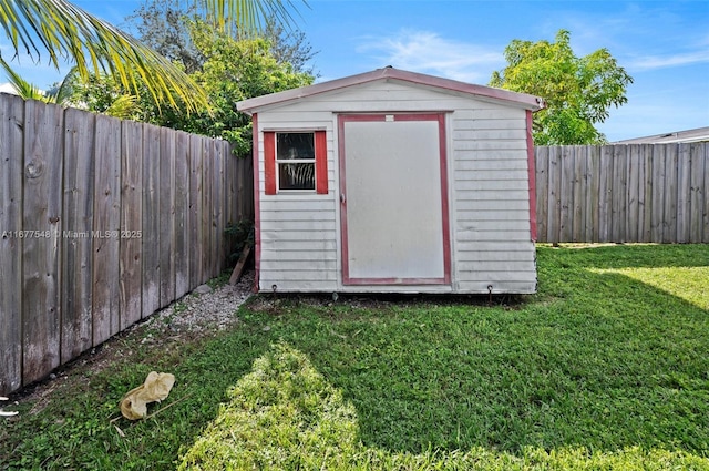 view of outbuilding with a yard