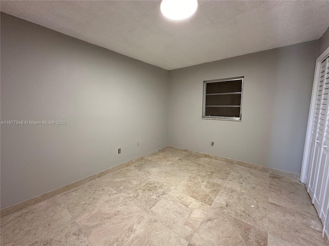 spare room featuring a textured ceiling