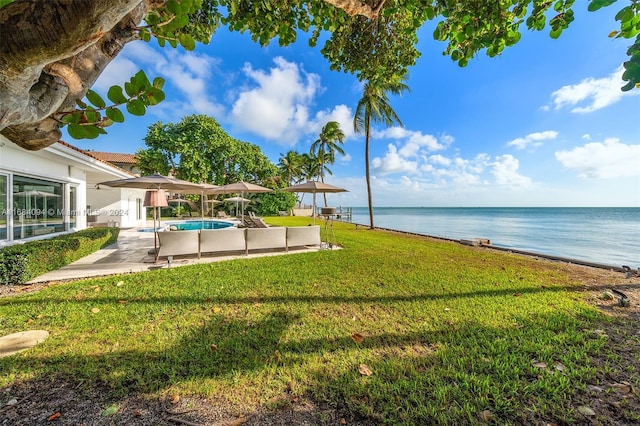 520 S Mashta Dr, Key Biscayne, FL 33149 - view of green lawn with a water view, an outdoor pool, and a patio area