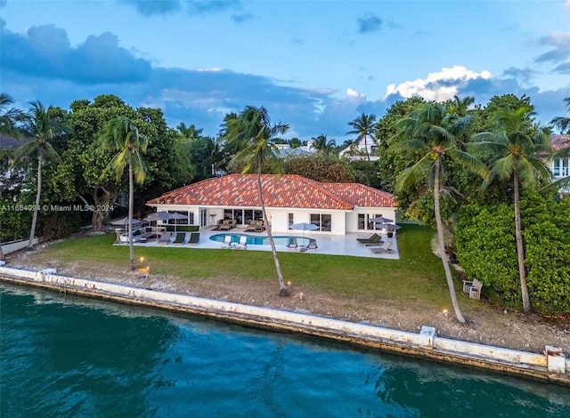 520 S Mashta Dr, Key Biscayne, FL 33149 - rear view of property with a patio area, an outdoor pool, a yard, and a water view