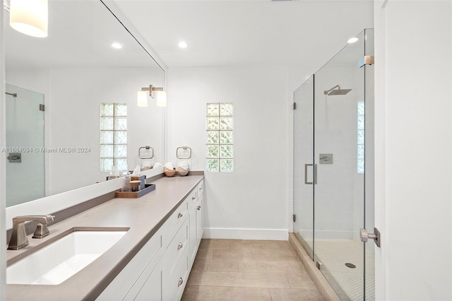 bathroom with vanity and a shower with shower door