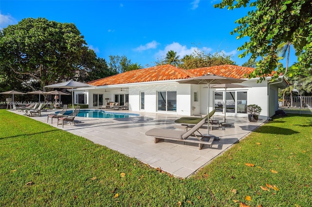 520 S Mashta Dr, Key Biscayne, FL 33149 - back of house featuring a tiled roof, a ceiling fan, stucco siding, a patio area, and an outdoor pool