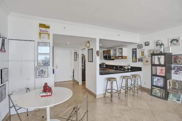 tiled dining room featuring ornamental molding