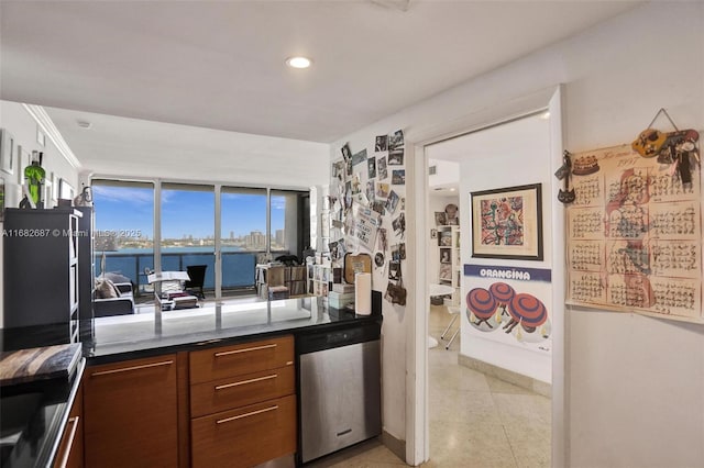 kitchen with stainless steel dishwasher and a water view