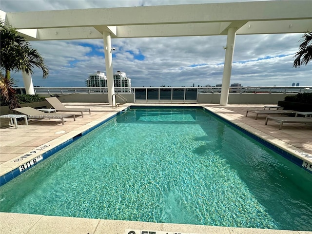 view of swimming pool featuring a patio area