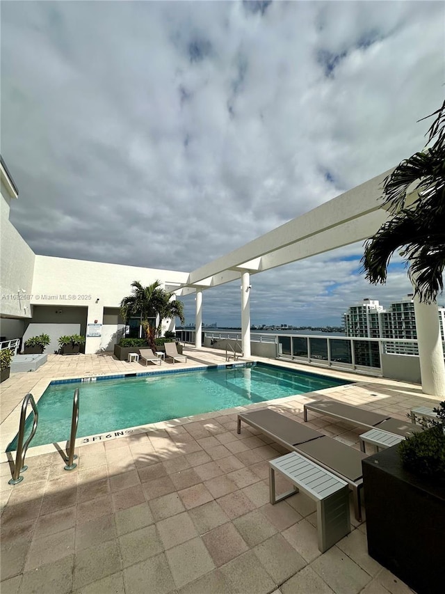 view of swimming pool with a patio