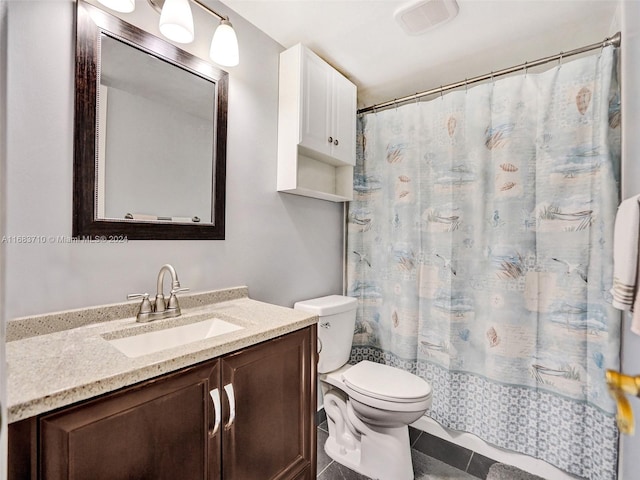 bathroom featuring toilet, walk in shower, vanity, and tile patterned flooring