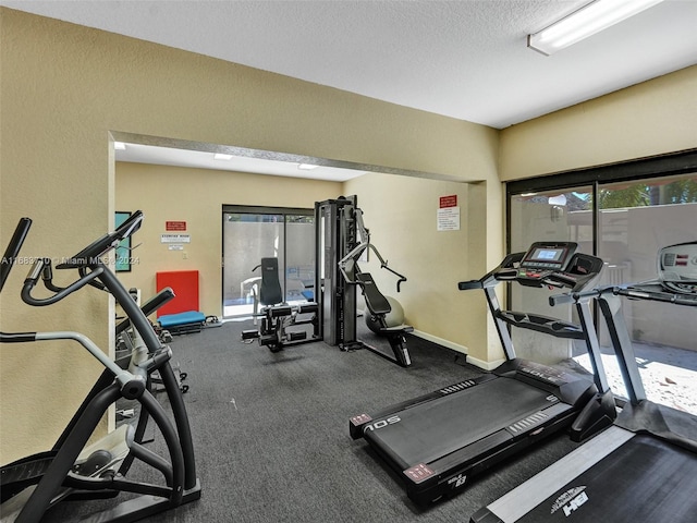 exercise room featuring a textured ceiling