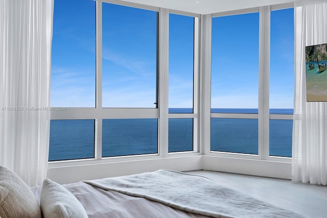 unfurnished bedroom featuring a water view