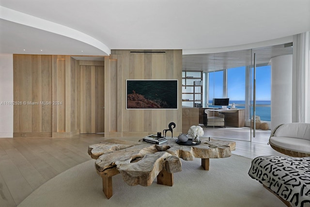 living room featuring hardwood / wood-style flooring and wooden walls