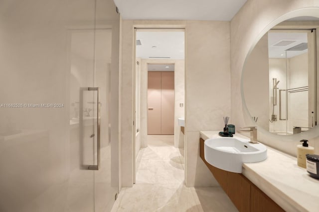 bathroom featuring vanity and a shower with shower door