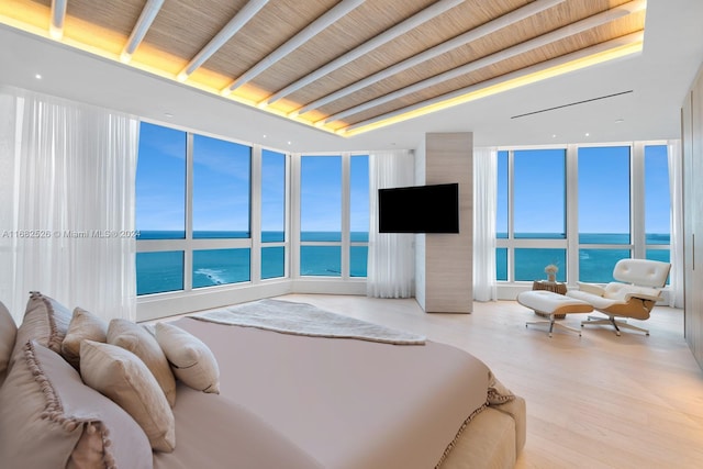 bedroom featuring light hardwood / wood-style floors and expansive windows