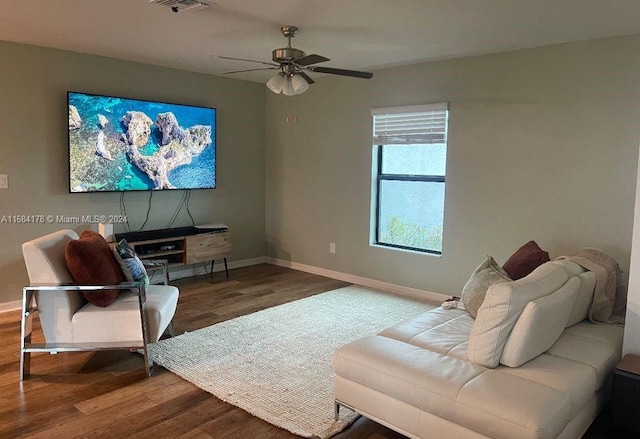 living room featuring hardwood / wood-style floors and ceiling fan