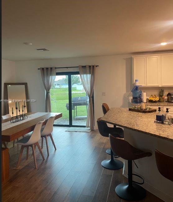 dining area with dark wood-type flooring