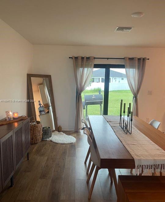 dining area with hardwood / wood-style flooring