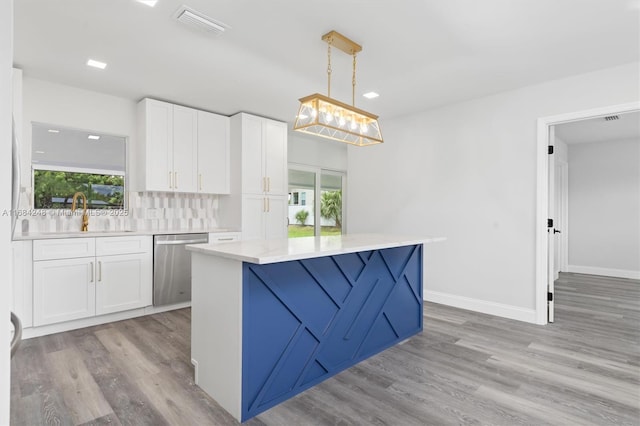 kitchen with decorative backsplash, decorative light fixtures, dishwasher, white cabinets, and sink