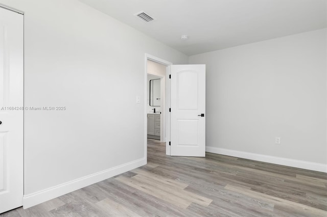 spare room featuring light hardwood / wood-style floors