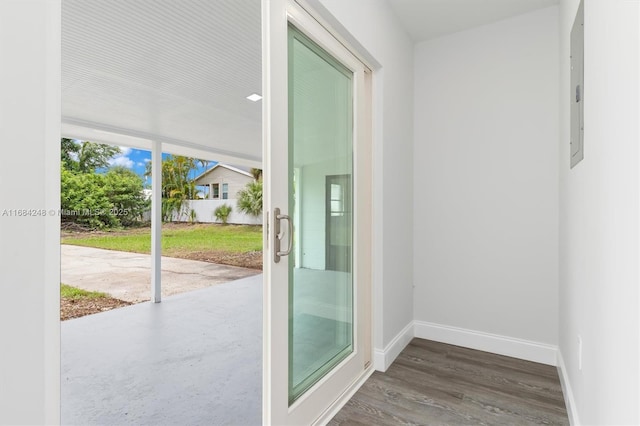 doorway to outside featuring dark wood-type flooring and electric panel