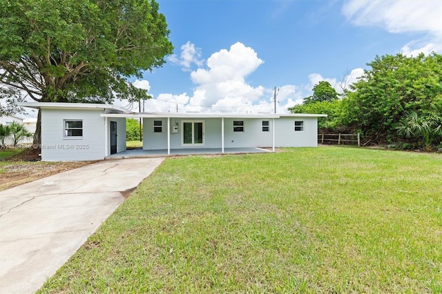 ranch-style home featuring fence and a front yard