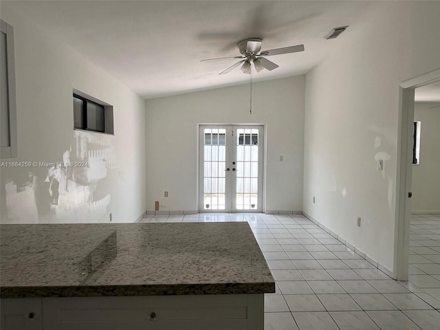 spare room featuring french doors, vaulted ceiling, ceiling fan, and light tile patterned flooring