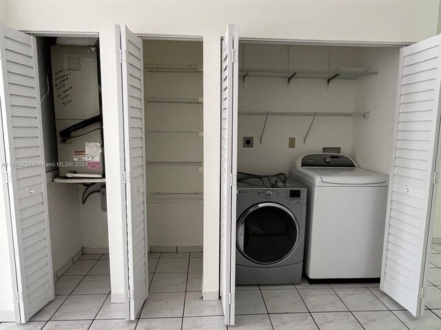 washroom with separate washer and dryer and light tile patterned floors