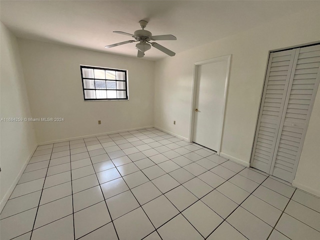 unfurnished bedroom featuring ceiling fan and light tile patterned flooring