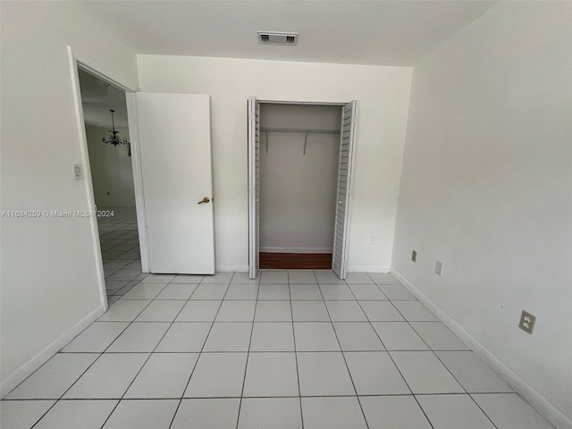 unfurnished bedroom featuring a closet and light tile patterned floors