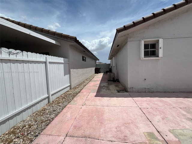 view of home's exterior with a patio area and central AC