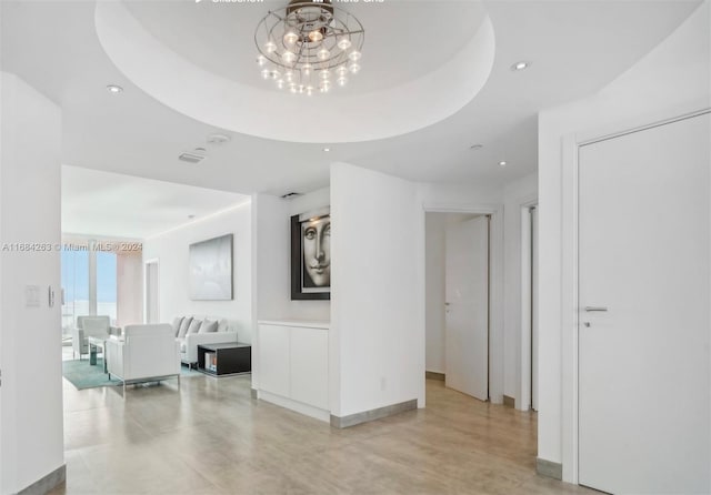 hallway with a raised ceiling