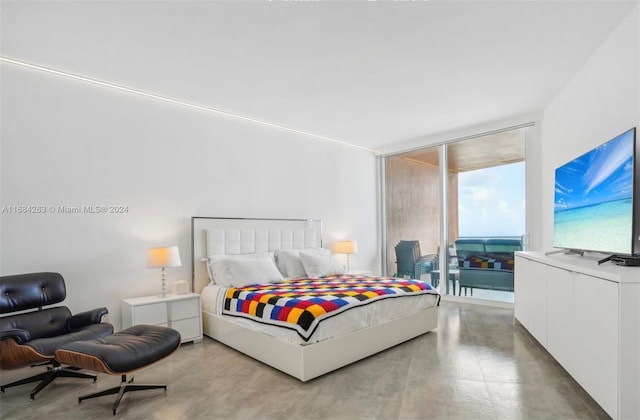 bedroom featuring a wall of windows and access to outside