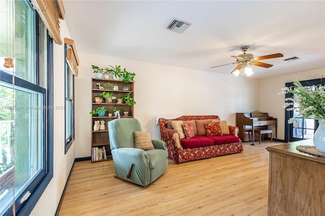 living room featuring light hardwood / wood-style floors and ceiling fan