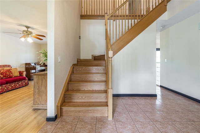 stairs with ceiling fan and wood-type flooring